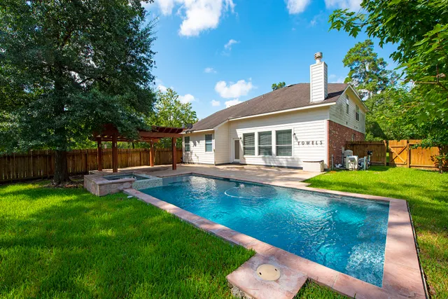 a view of a house with a yard deck and a small park