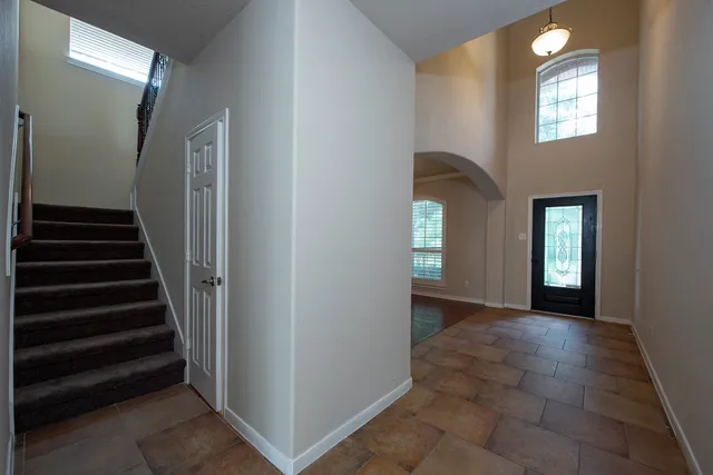 a view of an entryway with wooden floor and a living room