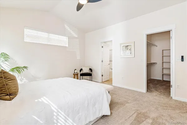 a bedroom with a bed and a painting on the wall