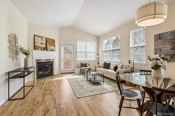 a living room with furniture a fireplace and a large window