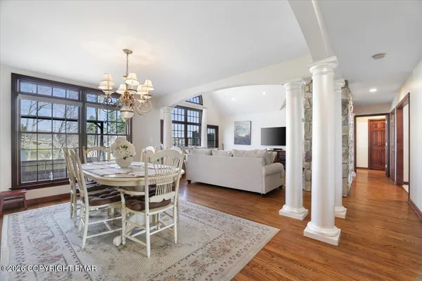 a kitchen with stainless steel appliances a dining table chairs stove refrigerator and sink