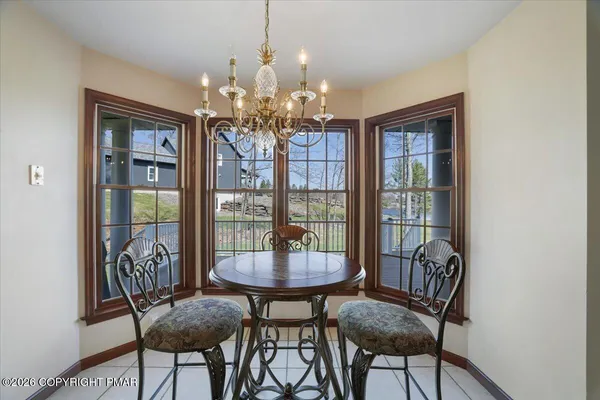 a spacious bathroom with a tub sink and mirror