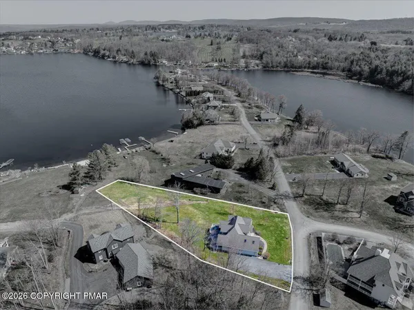 an aerial view of a house with a lake view