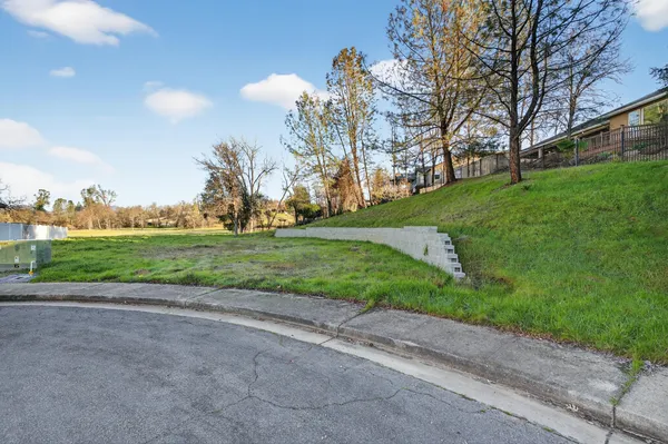 an aerial view of a house with a garden and lake view