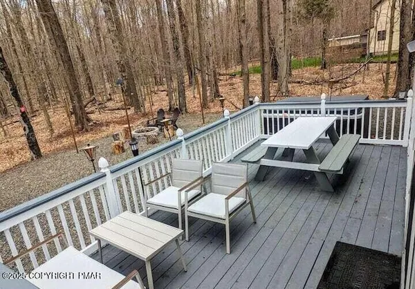 a view of a wooden chairs on the deck