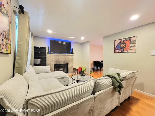 a living room with furniture a fireplace and a flat screen tv