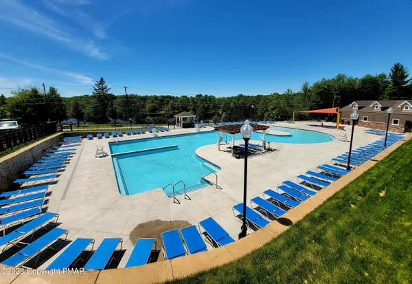 a view of a swimming pool with a chair and tables