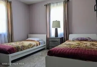 a bedroom with a bed lamp and window