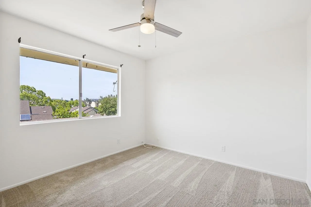 143 Cerco Rosado San Marcos, CA 92069 - Photo 15 of 28 an empty room with a window and a ceiling fan