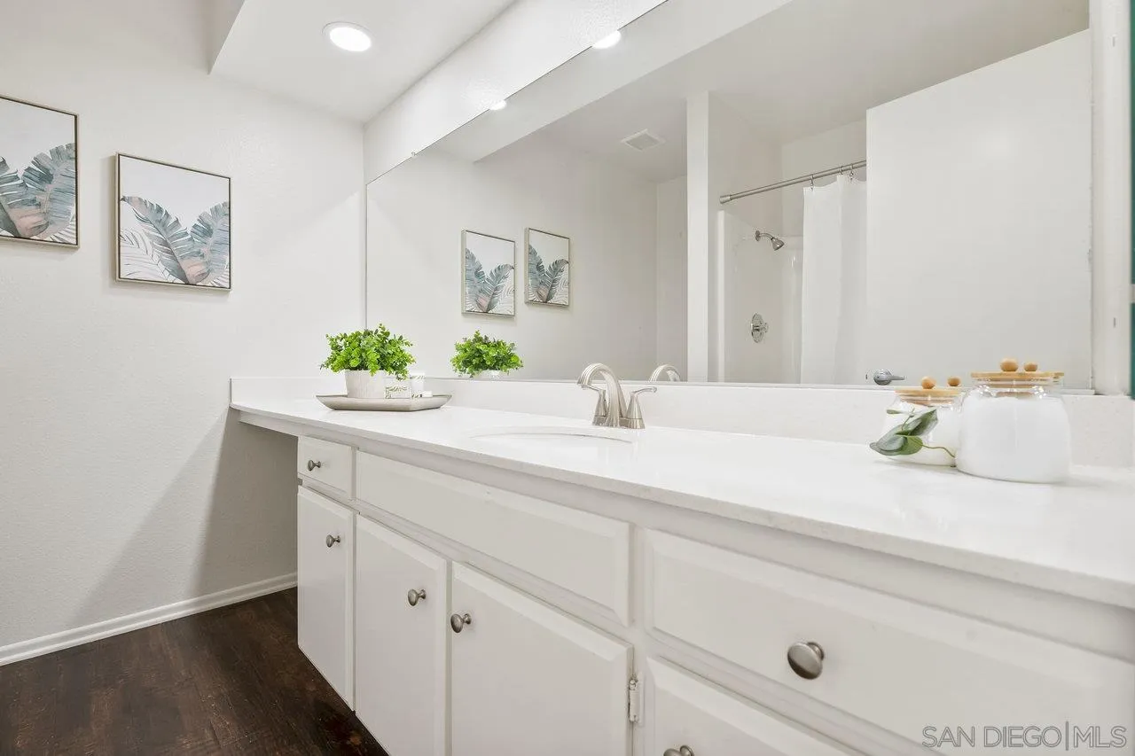 143 Cerco Rosado San Marcos, CA 92069 - Photo 19 of 28 a bathroom with a sink and a mirror