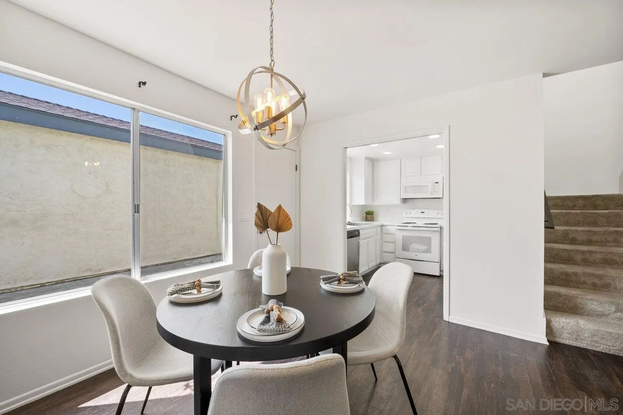 143 Cerco Rosado San Marcos, CA 92069 - Photo 6 of 28 a view of a dining room with furniture wooden floor and chandelier