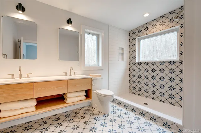 a bathroom with a sink toilet and mirror