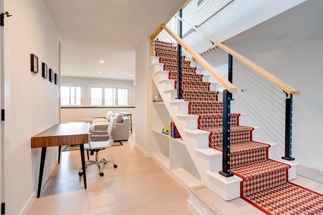 a view of a balcony with wooden floor and iron fence