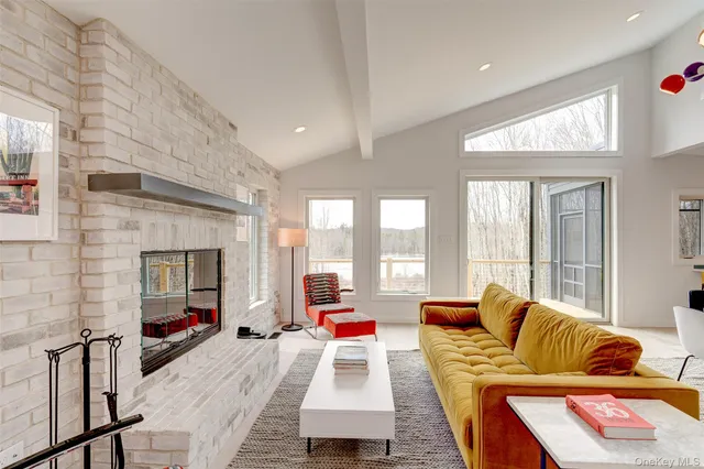 a living room with patio furniture and a fireplace