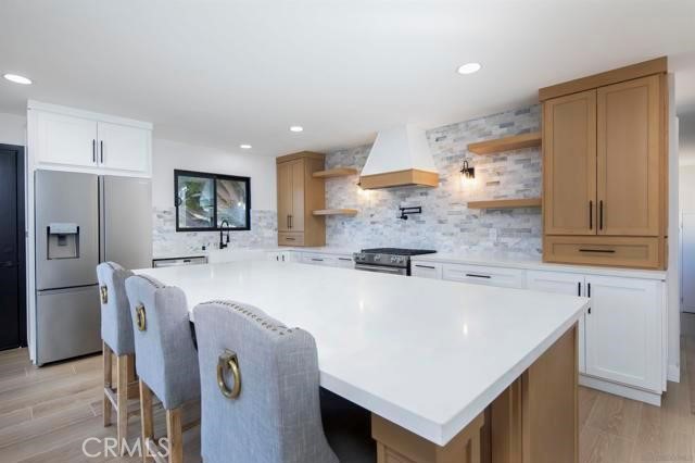 14085 Proctor Valley Road Jamul, CA 91935 - Photo 11 of 70 a large kitchen with stainless steel appliances a sink a refrigerator and a stove