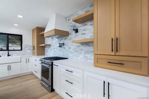 a kitchen with white cabinets and white appliances