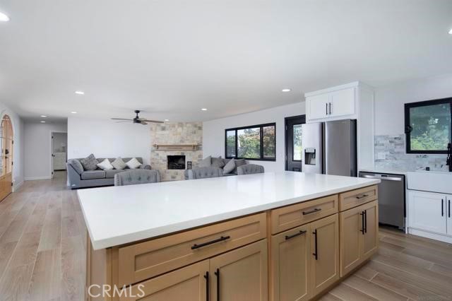 14085 Proctor Valley Road Jamul, CA 91935 - Photo 13 of 70 a living room with stainless steel appliances kitchen island granite countertop a refrigerator a sink dishwasher a oven with white cabinets and wooden floor