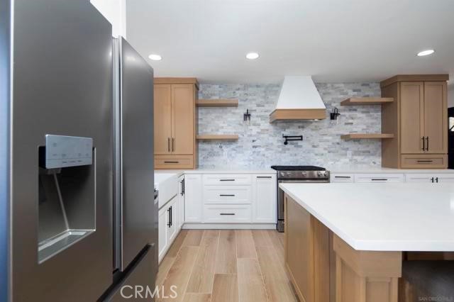 14085 Proctor Valley Road Jamul, CA 91935 - Photo 15 of 70 a kitchen with white cabinets and white appliances