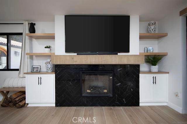 14085 Proctor Valley Road Jamul, CA 91935 - Photo 17 of 70 a living room with a fireplace and a flat screen tv
