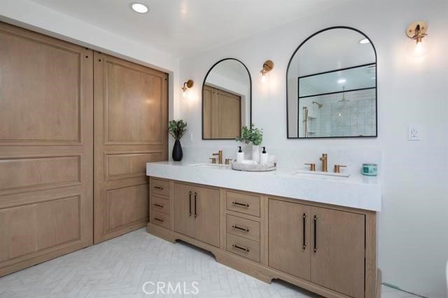 14085 Proctor Valley Road Jamul, CA 91935 - Photo 22 of 70 a bathroom with a double vanity sink and a mirror