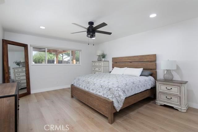 14085 Proctor Valley Road Jamul, CA 91935 - Photo 25 of 70 a bedroom with a large bed and a chandelier