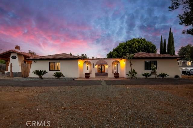 14085 Proctor Valley Road Jamul, CA 91935 - Photo 3 of 70 a front view of a house with a yard and garage