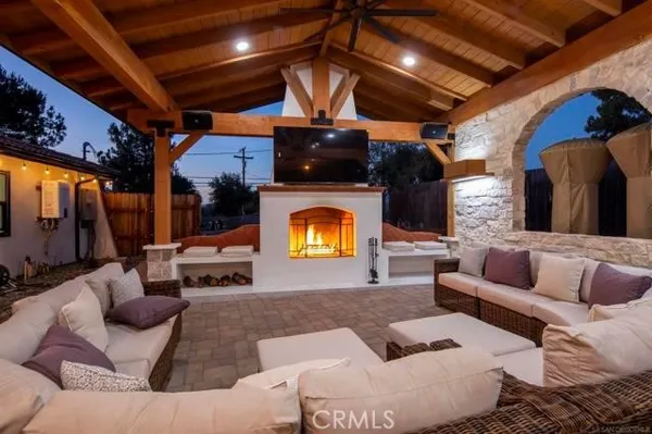 a outdoor space with patio the couches and pool dining table and chairs with wooden floor