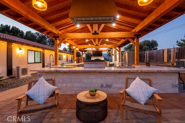 14085 Proctor Valley Road Jamul, CA 91935 - Photo 35 of 70 a patio with glass top table and chairs