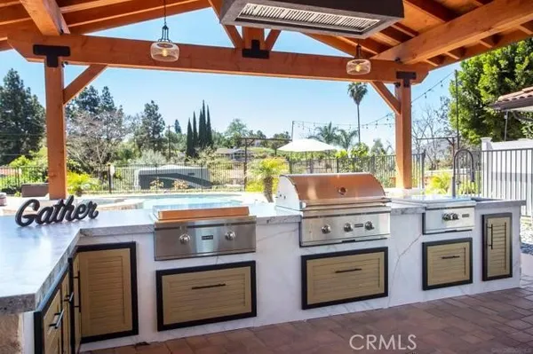 an aerial view of a house with a yard and a large tree