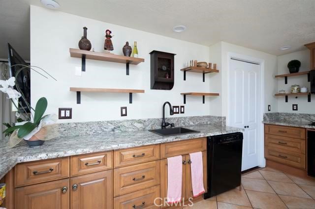 14085 Proctor Valley Road Jamul, CA 91935 - Photo 61 of 70 a kitchen with granite countertop a sink and cabinets