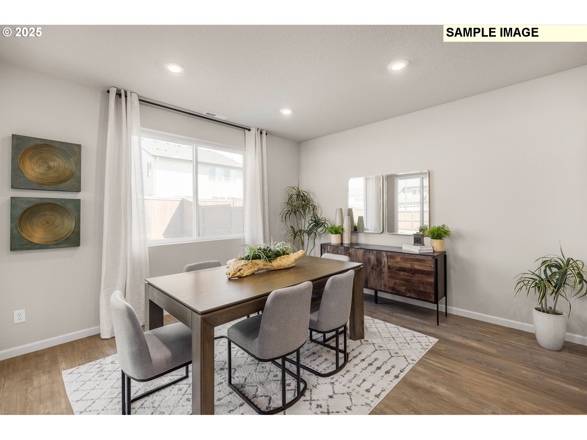 8842 Southwest Choke Cherry Tualatin, OR 97062 - Photo 11 of 29 a view of a dining room with furniture and wooden floor