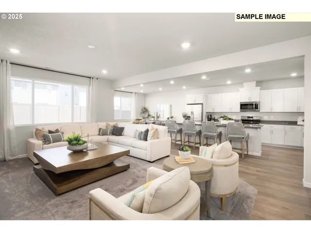 a living room with furniture kitchen and a table