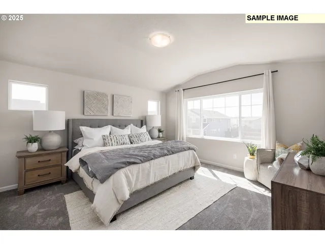 a bedroom with a large bed and a large window