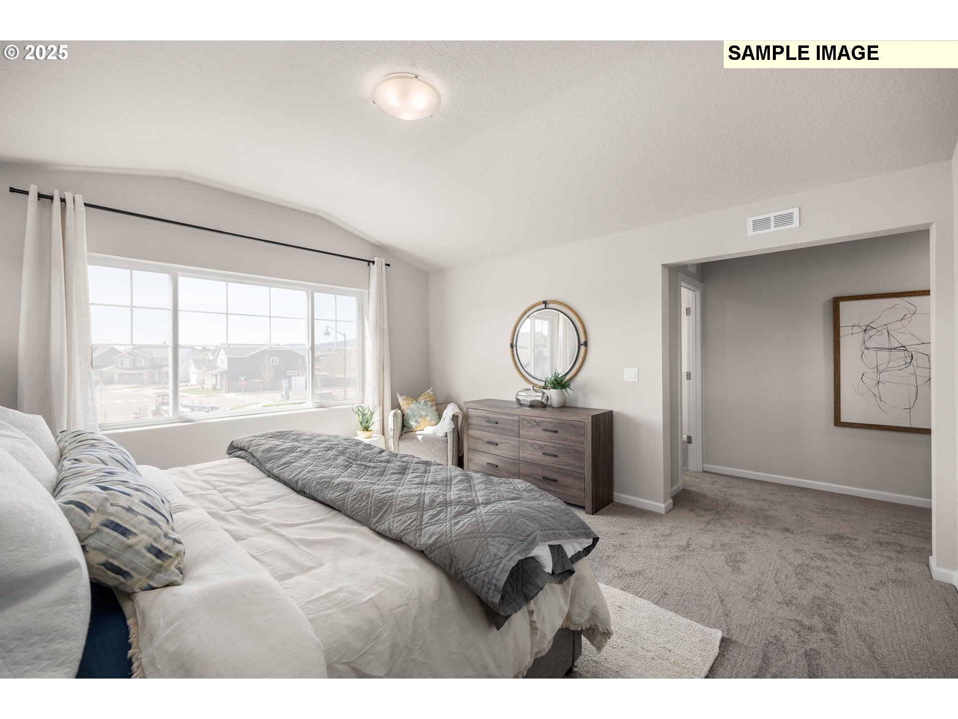 8842 Southwest Choke Cherry Tualatin, OR 97062 - Photo 17 of 29 a bedroom with a bed and large windows