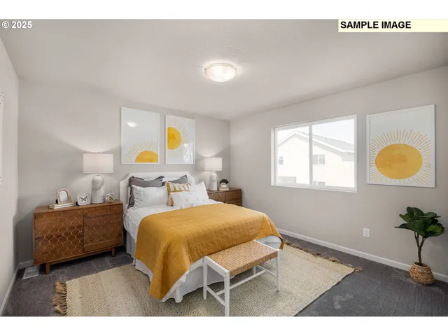 a bedroom with a bed and a painting on the wall