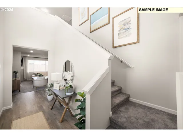 a living room with furniture and stairs