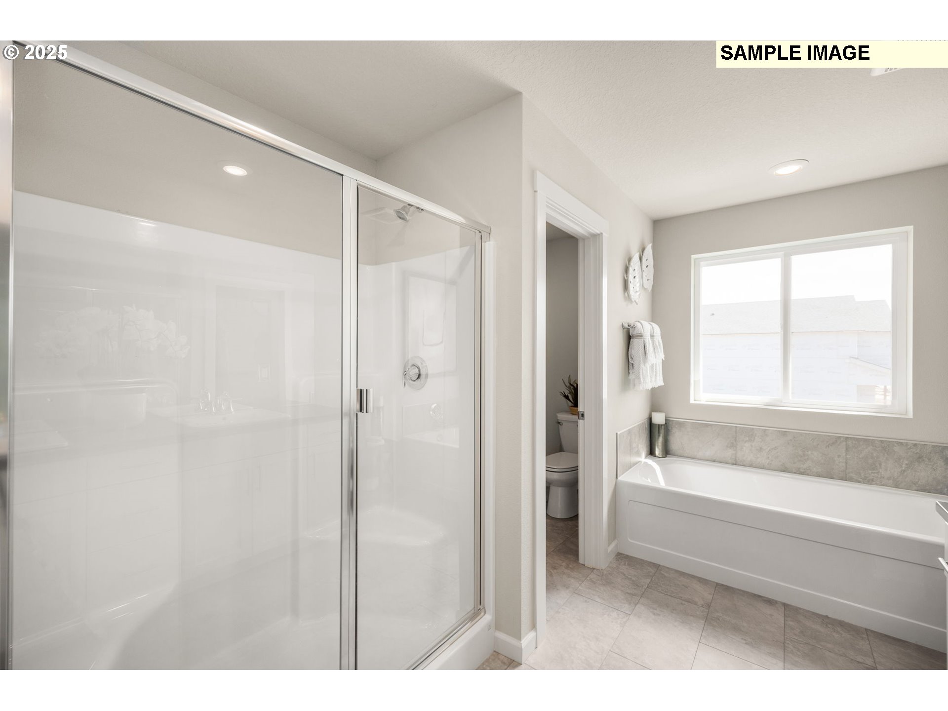 8842 Southwest Choke Cherry Tualatin, OR 97062 - Photo 23 of 29 a bathroom with a bathtub and a shower