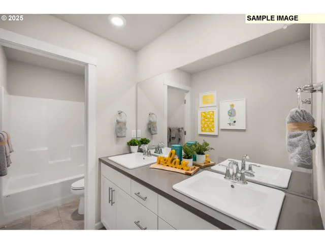 a bathroom with a sink vanity granite tub shower and a mirror