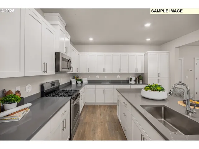 a kitchen with a sink stove top oven and microwave