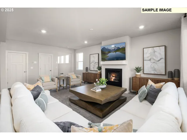 a living room with furniture a fireplace and paintings on wall