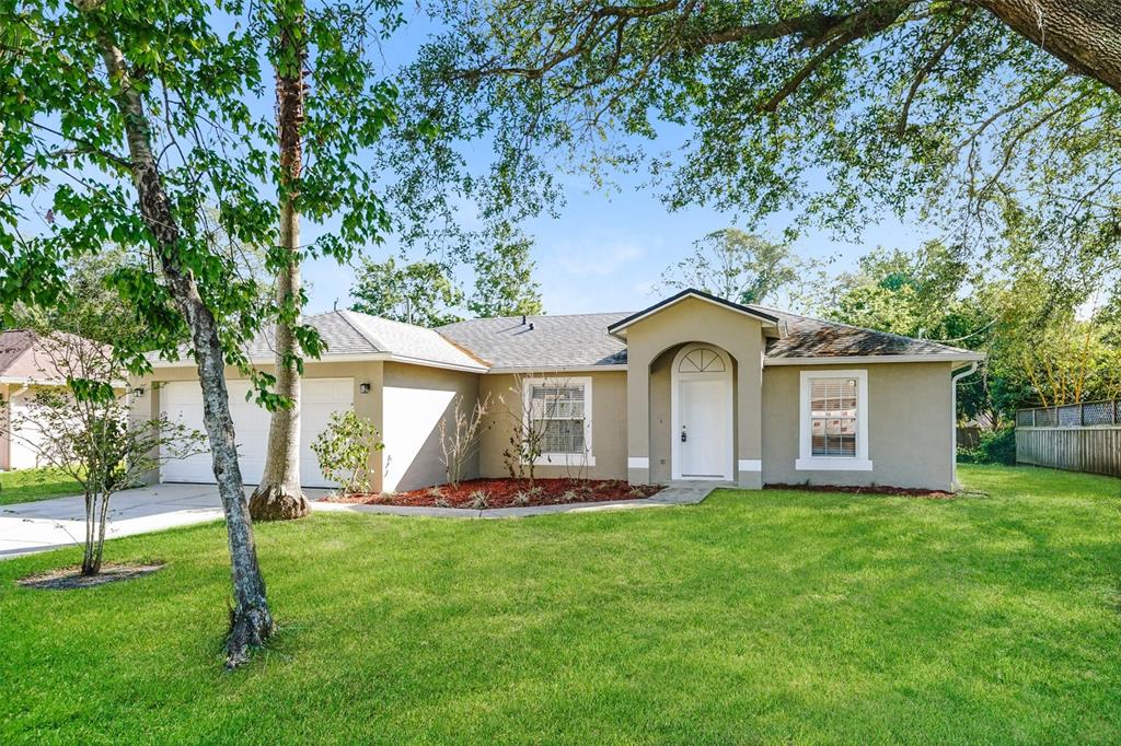 a front view of a house with garden and green space