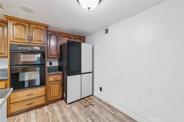 a kitchen with stainless steel appliances a refrigerator and cabinets