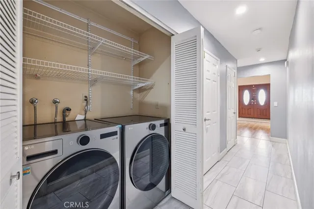 a view of a hallway with washer and dryer