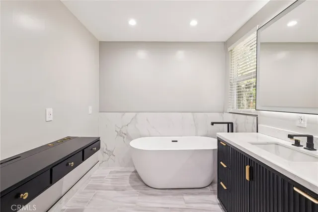 a bathroom with a double vanity sink and a bathtub