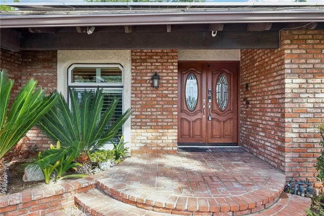 a front view of a house with a potted plant