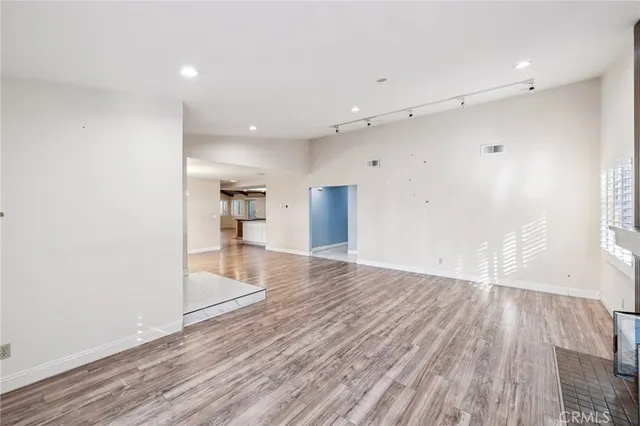 a view of a room with wooden floor and a window