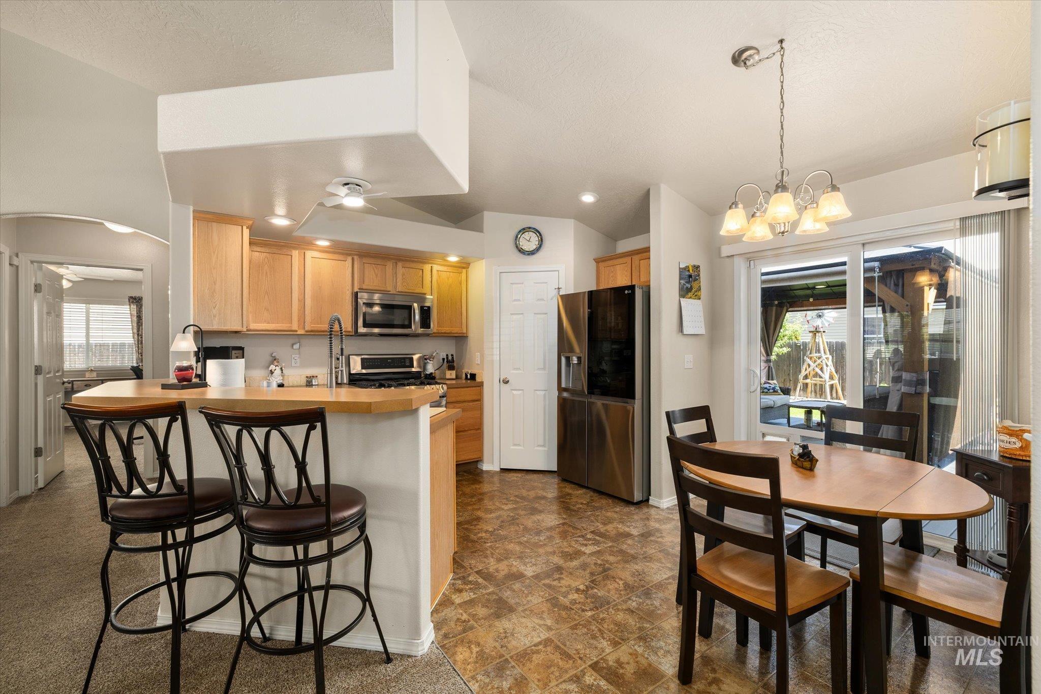 5401 Barkley Way Caldwell, ID 83607 - Photo 19 of 35 Open-concept kitchen featuring light wood cabinetry, stainless steel appliances, a breakfast bar, and recessed lighting