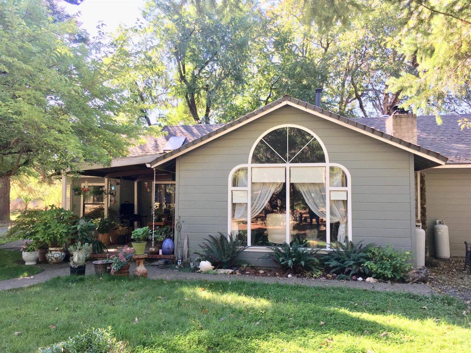 300 Grange Road Grants Pass, OR 97526 - Photo 3 of 27 a front view of white house with a yard and potted plants