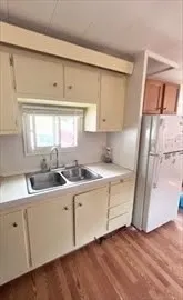 a kitchen with a sink cabinets and window