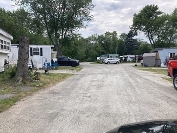 1515 VFW Parkway, Unit M19 Boston, MA 02132 - Photo 11 of 13 a view of backyard with a table and chairs under an umbrella
